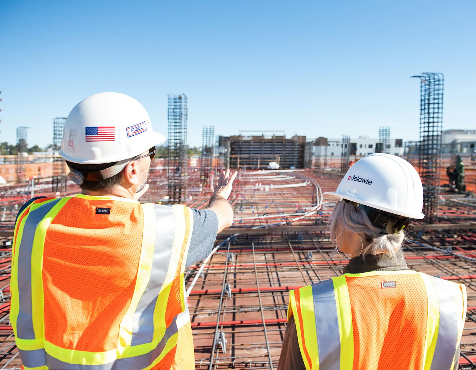 man in white hard hat standing on brown wooden dock during daytime contractors